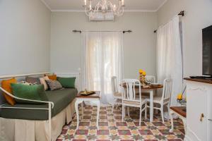 a living room with a couch and a table at Giannis Papoutsis in Posidhonía
