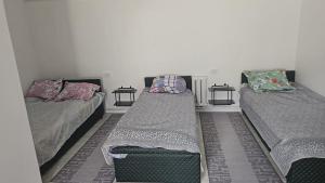 a room with two beds and two pillows at Tumar in Saty