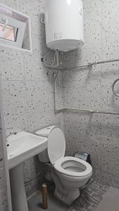 a bathroom with a toilet and a sink at Tumar in Saty