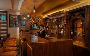 a man sitting at a bar in a pub at Shobla Royale in Kulu