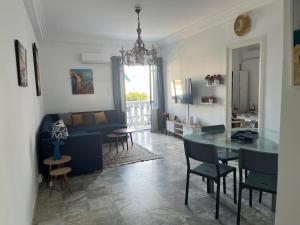 a living room with a table and a couch at Beau appt vue mer à gammarth in Gammarth