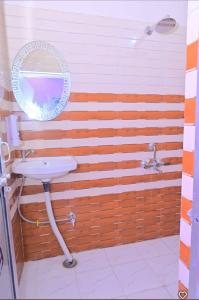 a bathroom with a sink and a mirror at Abhishek chand kaushik guest House in Ayodhya