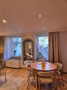 a dining room with a table and chairs and a mirror at DORMAR I Apartament in Wałbrzych