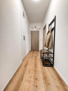 a hallway with a mirror and white walls at Centrum apartment in Brno