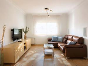 a living room with a couch and a tv at Sa Torre in Llucmajor