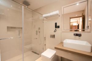 a bathroom with a shower and a sink and a toilet at OCEAN PEARL in Visakhapatnam +50 photos