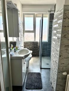 a bathroom with a sink and a toilet and a shower at Central City Apartment of Asti in Asti