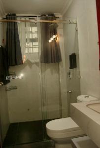 a bathroom with a shower with a toilet and a sink at Villaveh Gameview in Nakuru +53 photos