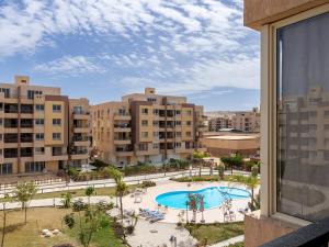 a view of a swimming pool from a building at Pool view- Luxurious 3BD Hotel Apt, Sheikh Zayed in Kafr Abū ʼumaydah