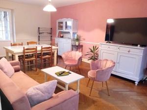 a living room with a table and a dining room at Charming house in Montbron