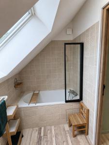 a bathroom with a bath tub in a attic at Casa Terracotta in Saint-Aignan +28 photos