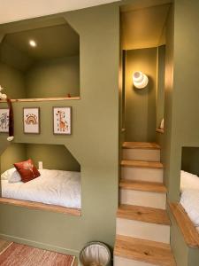 a small bedroom with a bed and a staircase at Casa Terracotta in Saint-Aignan