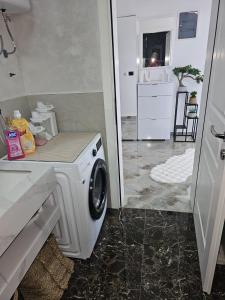 a washer and dryer in a room with a kitchen at Villa Nova Bar in Bar