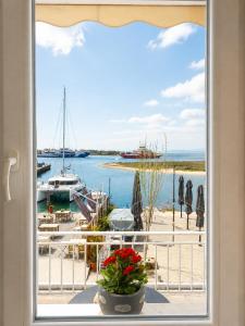 a window with a view of a harbor with boats at Sophia House in Keramoti