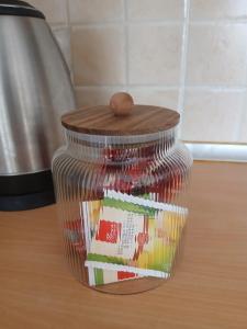 a glass jar with a wooden lid on a table at Apartmani, prenoćište Ana in Tomislavgrad