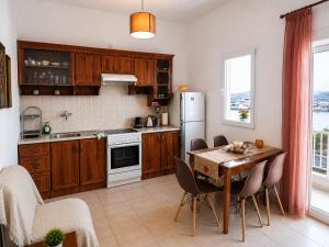 a kitchen with a table and a refrigerator at Sophia House in Keramoti