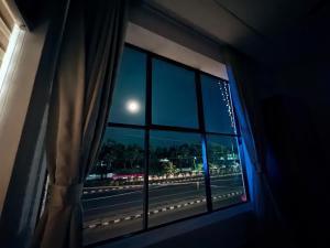 a view from a window at night with a full moon at Mahadeva Residency in Trivandrum
