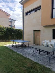 two ping pong tables and chairs in a yard at La Vega in Cardeñadijo