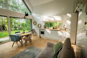 a kitchen and living room with a couch and a table at SoboLove in Sobolów