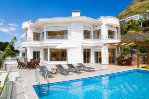 a villa with a swimming pool and a house at Villa Azure Heaven in Turgutreis