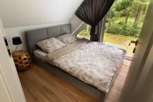 a bed in a room with a window at SoboLove in Sobolów