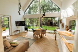a kitchen and living room with a table and chairs at SoboLove in Sobolów