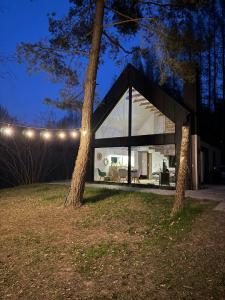 a glass house with two trees in front of it at SoboLove in Sobolów