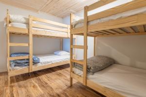 a bunk bed room with two bunk beds at Diamond Lakehouse | SUP, Canoe, BBQ, Aurora Magic in Highland Grove