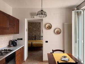 a kitchen with a table and a dining room at Antica Interamnia in Teramo +31 photos