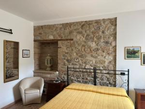 a bedroom with a bed and a stone wall at Antica Interamnia in Teramo