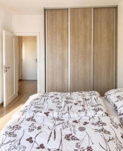 a bedroom with a bed with a floral bedspread at Apartmán centrum BB s balkónom a parkovaním in Banská Bystrica