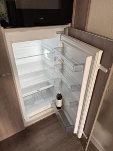 an empty refrigerator with its door open in a kitchen at Vakantiehuis 6 personen ENL Boutique 92 in Ewijk