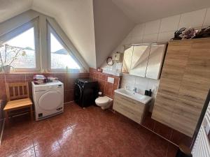 a large bathroom with a sink and a toilet at Am Berg und See in Stemwede +21 photos