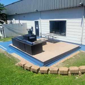 a patio with a couch and a table on it at Home Place Suites in Bartlesville