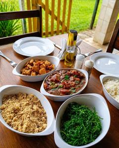 a wooden table with dishes of food on it at Pousada Quinta de Areal in Areal