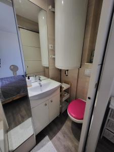 a small bathroom with a sink and a toilet at Beach 50 m , vue mer in Carnon-Plage
