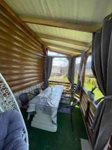 a room with a bed and chairs in a camper at Sosnova hilka in Mykulychyn