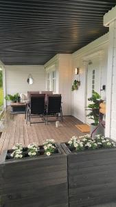 a porch with chairs and a table and some plants at Vetlebekken Apartment close to Trolltunga in Steinaberg