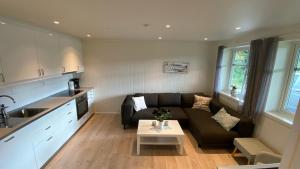a living room with a couch and a table at Vetlebekken Apartment close to Trolltunga in Steinaberg