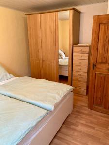 a bedroom with a bunk bed and a dresser at Ferienhaus Alter Hof in Volkach