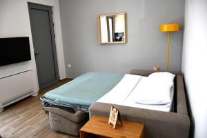 a hotel room with a bed and a television at My Gytheio Apartment in Gythio