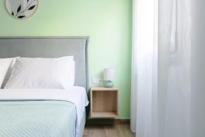 a bedroom with a bed and a clock on the wall at My Gytheio Apartment in Gythio