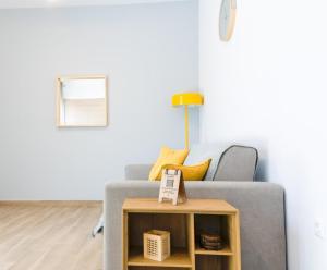 a living room with a gray couch and a table at My Gytheio Apartment in Gythio