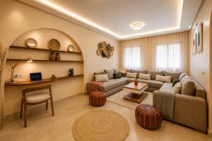 a living room with a couch and a table at Babylone Appart & Pool, Hivernage in Marrakesh