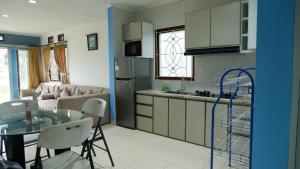 a kitchen and living room with a table and chairs at villa NC3 31 Kota Bunga in Cikundul