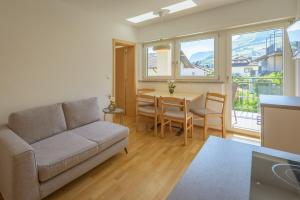 a living room with a couch and a table at Ferienwohnungen Atz in Termeno