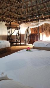 a room with two beds and a table and a bed at El cielo hotel isla fuerte in Puerto Limón