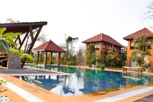 an image of a swimming pool at a resort at Vannraj Resort And Spa in Khawāsa