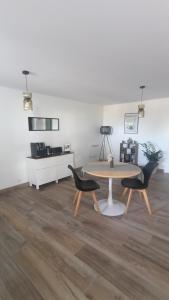 a dining room with a table and two chairs at Chambre d'hôtes Bidegaina in Ahetze