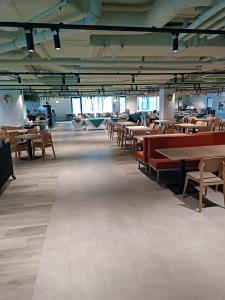 an empty room with tables and chairs and tablesktop at Bel Mare Aqua 2 F504 in Międzyzdroje